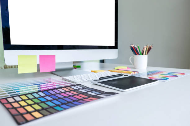 istock Modern office workplace with tablet, Graphic designer and color swatch samples at workplace 1251185143