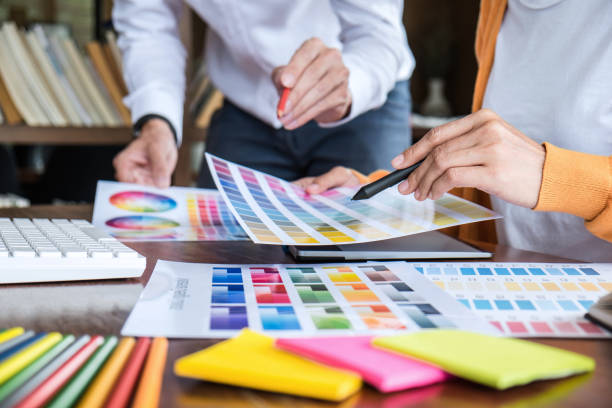 istock Two colleagues creative graphic designer working on color selection and drawing on graphics tablet at workplace 1251185322