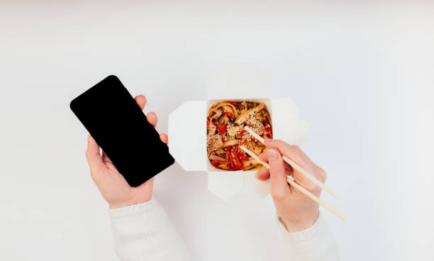 istock Woman eating chinese takeaways 1251185374