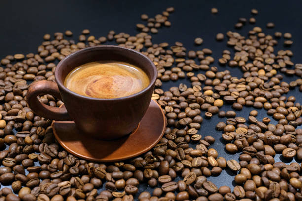 istock A cup of coffee on coffee beans on the table. 1251185488