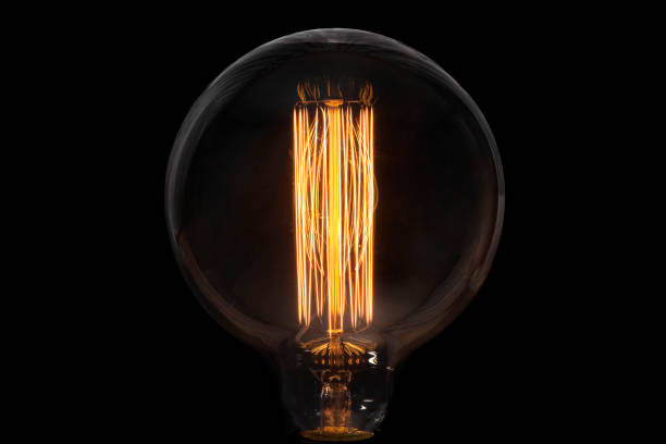 istock Incandescent lamp on a dark background, concept of creativity. 1251185505