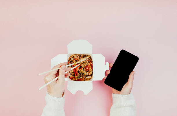 istock Woman eating chinese takeaways 1251185562