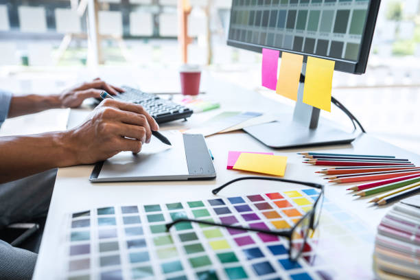 istock Image of male creative graphic designer working on color selection and drawing on graphics tablet at workplace with work tools and accessories in workspace 1251185654