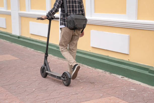 istock Male with a backpack on an electric scooter. Traveler backpacker 1251189354