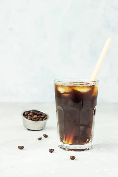 istock Espresso tonic, refreshment summer drink with tonic water, coffee and ice cubes, light grey concrete background. Trendy coffee drink. 1251190527
