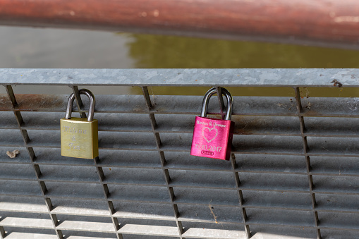 Bicycle locks attached to fence as a sign of love and security in Germany