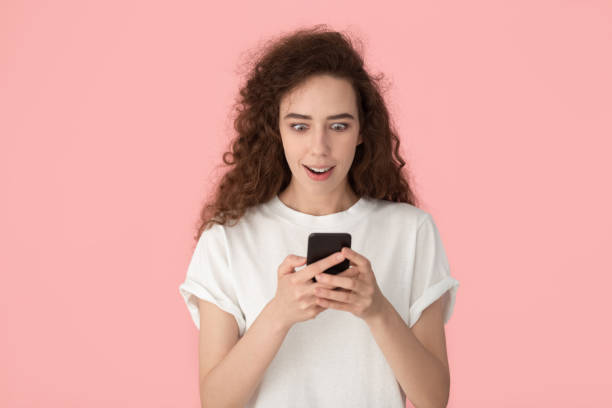 istock Amazed young female surprised by good message on cellphone 1251191428
