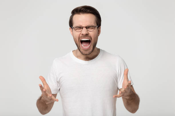 istock Furious man in glasses shout suffering from annoying sound 1251198904