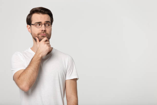istock Pensive man in glasses look at blank copy space thinking 1251198930
