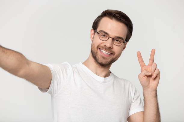 istock Smiling millennial man in glasses make selfie in studio 1251198937