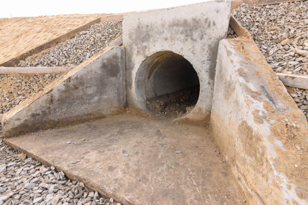 Installation of culvert drainage pipe and ditch structures under the highway stock photo