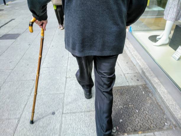 istock Disabled senior man walking with walking cane. 1251201236