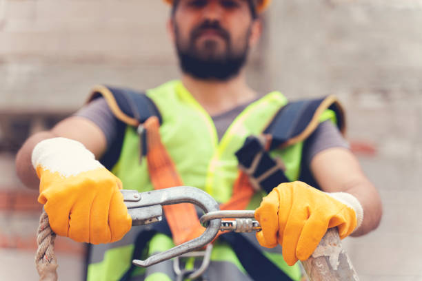 istock Working at height equipment. Fall arrestor device for worker with double hooks for safety body harness on selective focus. Construction as a background. 1251201359