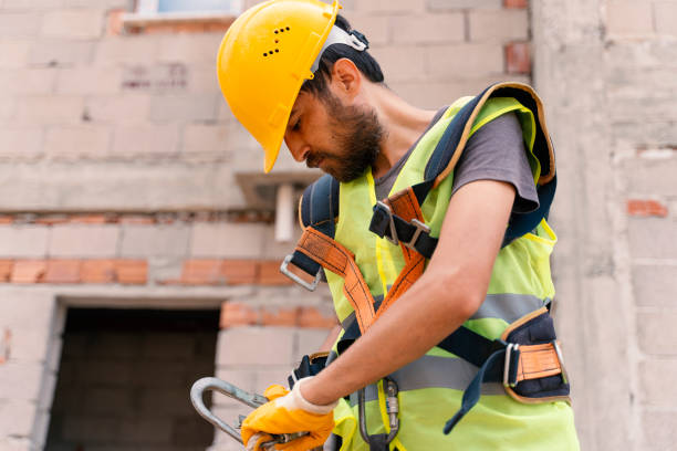 istock [safety body construction] Working at height equipment. Fall arrestor device for worker with hooks for safety body harness on selective focus. Construction background. 1251201399