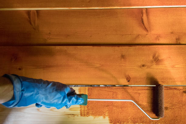 istock Hand painting wooden planks 1251203267