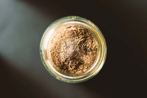 istock Powdered black pepper in glass jar 1251203297