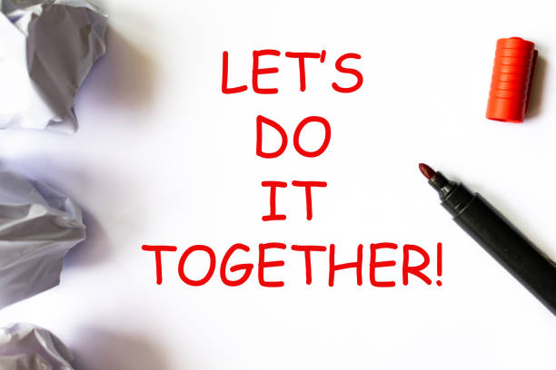 istock Let's do it together text on a white backround with red highlightr. Business startup or relationship concept. 1251205014