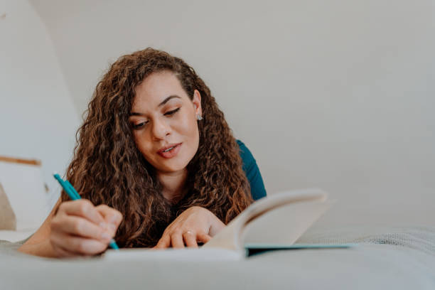 istock Mixed race latin woman reading a book 1251205178