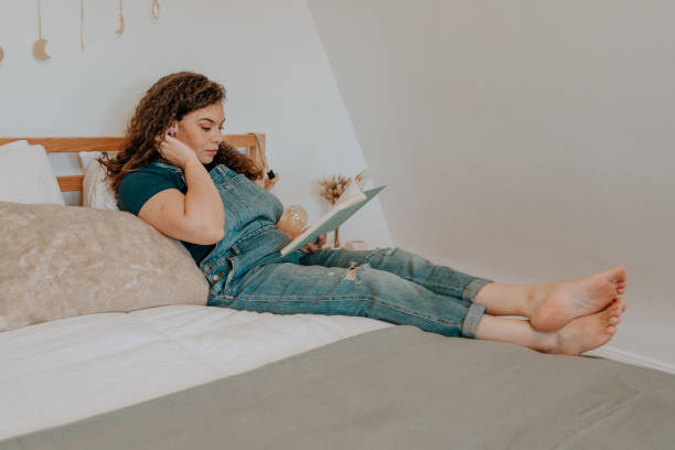 istock Mixed race latin woman reading a book 1251205182