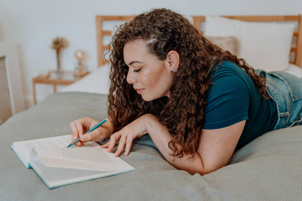 istock Mixed race latin woman reading a book 1251205225