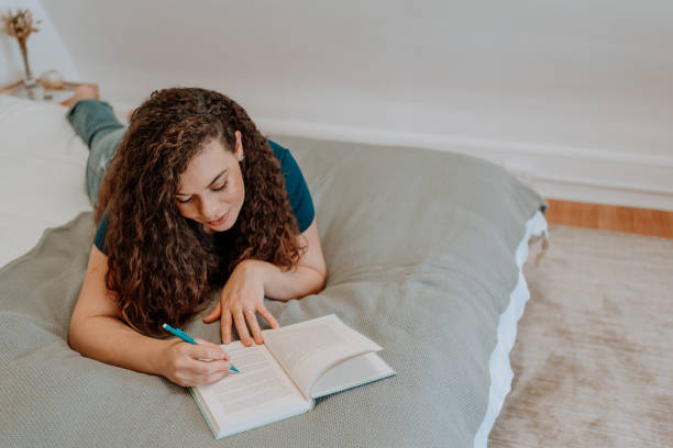 istock Mixed race latin woman reading a book 1251205337