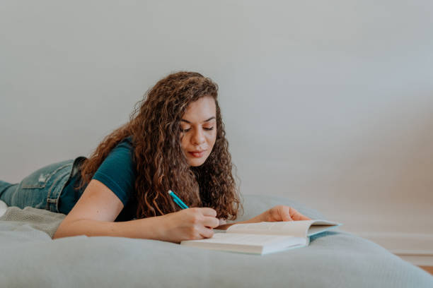 istock Mixed race latin woman reading a book 1251205888