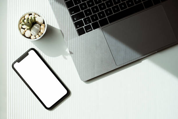 istock White blank screen smart phone mockup on the table 1251206077