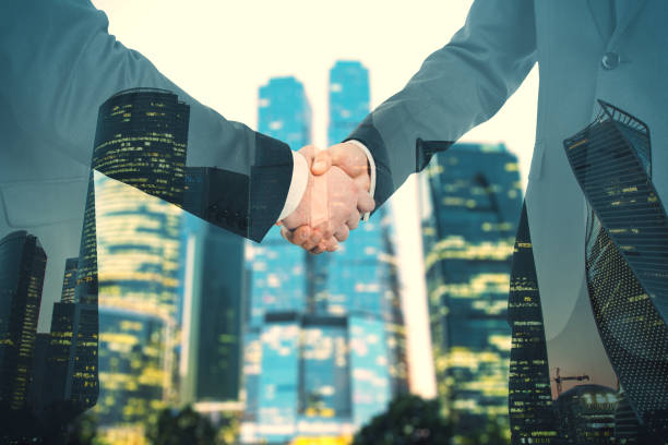 istock Handshake on night city background 1251208135