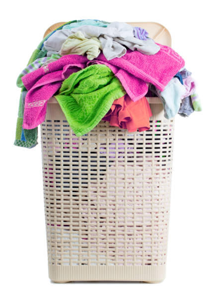istock Laundry basket full of dirty washing (isolated on white) 1251209775