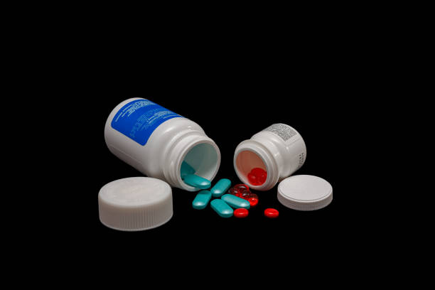 A white pill bottle with a white pill inside. High quality photo