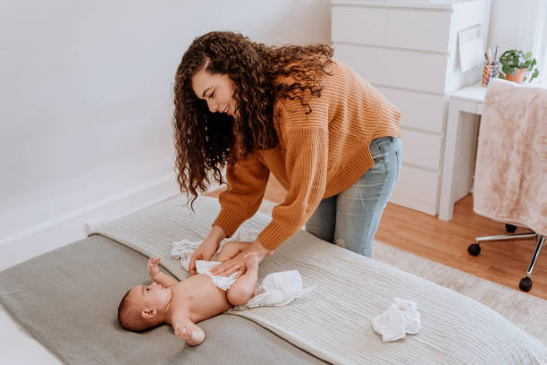 istock Mixed race latin mother changing her baby diaper 1251223002