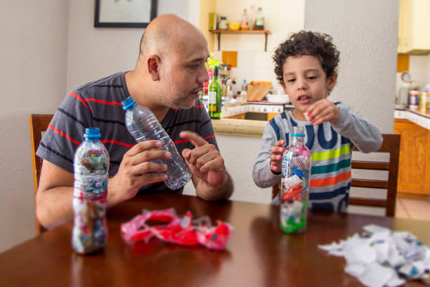 Father and son recycling, ecoladrillos