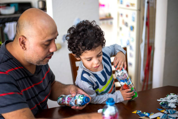 istock Father and son recycling, ecoladrillos 1251223173