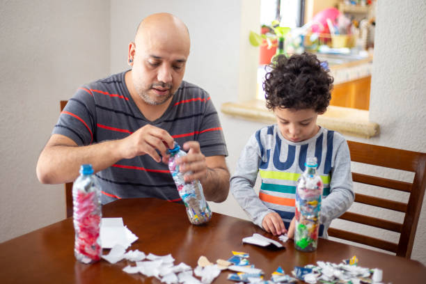 istock Father and son recycling, ecoladrillos 1251223182