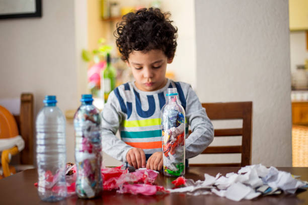 istock child recycling, ecoladrillos at home 1251223188