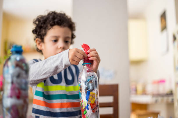 istock child recycling, ecoladrillos at home 1251223199