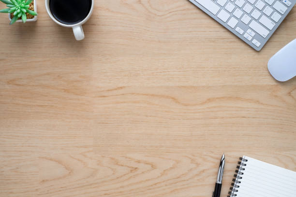 istock Wood office desk table with keyboard, notebook and coffee cup with equipment other office supplies. Business and finance concept. Flat lay with blank copy space. 1251223900