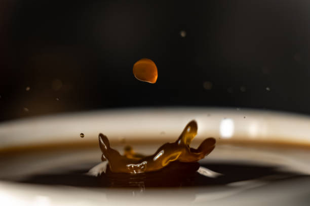 istock coffee splash and drop . macro close up brown liquid with smoke. 1251223961