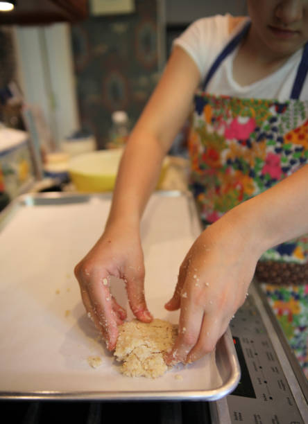 istock Girl making cookies on her kitchen. 1251223981