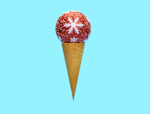 istock ice cream cone with red Christmas decorative ball on top on blue background 1251224809