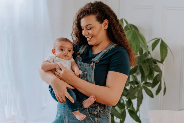 istock Mixed race mom holding her baby boy 1251226855
