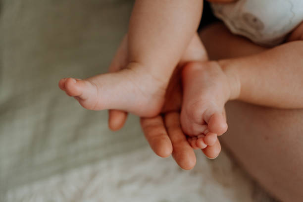 istock Mother holding baby's feet 1251226857