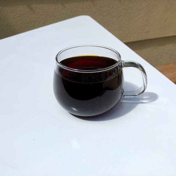 istock a glass of coffee on a white table 1251227085