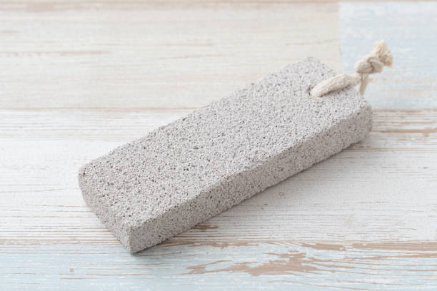 Pumice stone for skin care products Pumice stone for skin care products reflexology stone massaging human foot stock pictures, royalty-free photos & images