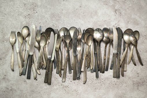 Old rusty utensils on gray grungy background