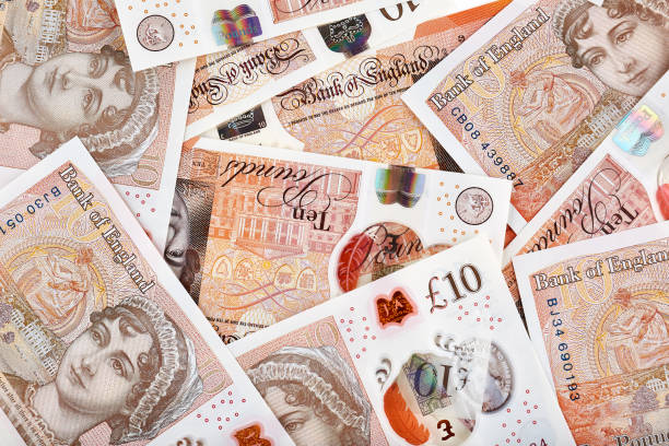 A lot of United Kingdom 10 pounds banknotes A lot of United Kingdom 10 pounds banknotes. Money horizontal background. british currency photos stock pictures, royalty-free photos & images