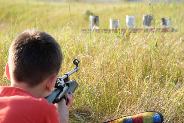 Little boy shooting with air rifle (landscape)