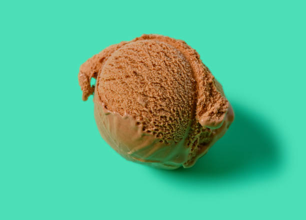 istock top view chocolate ice cream ball on green background 1251233598