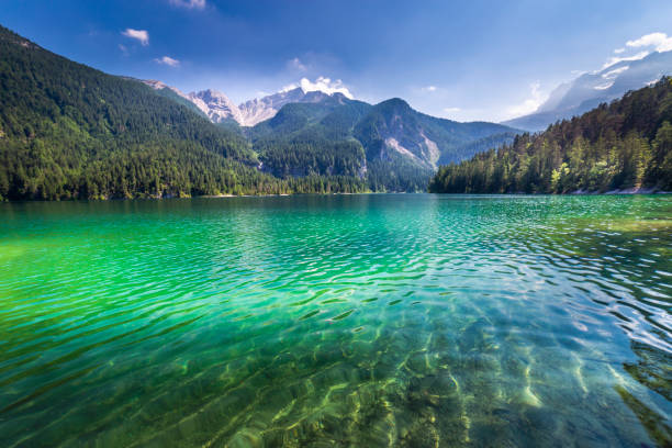 ethereal translucent lake tovel landscape – trentino, dolomites – italy - international landmark sunny lake sky imagens e fotografias de stock