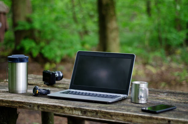 istock Computer Coffee Mug and Telephone on black wood table. 1251242995